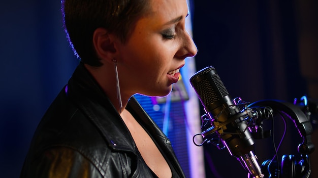 Professional singing lessons instructor demonstrating vocal techniques for students learning music performance skills